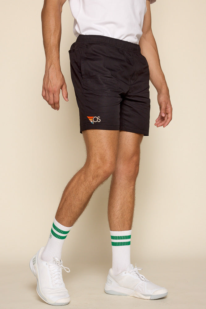 Cropped frontal view of male model wearing our "Flying P" league shorts in black