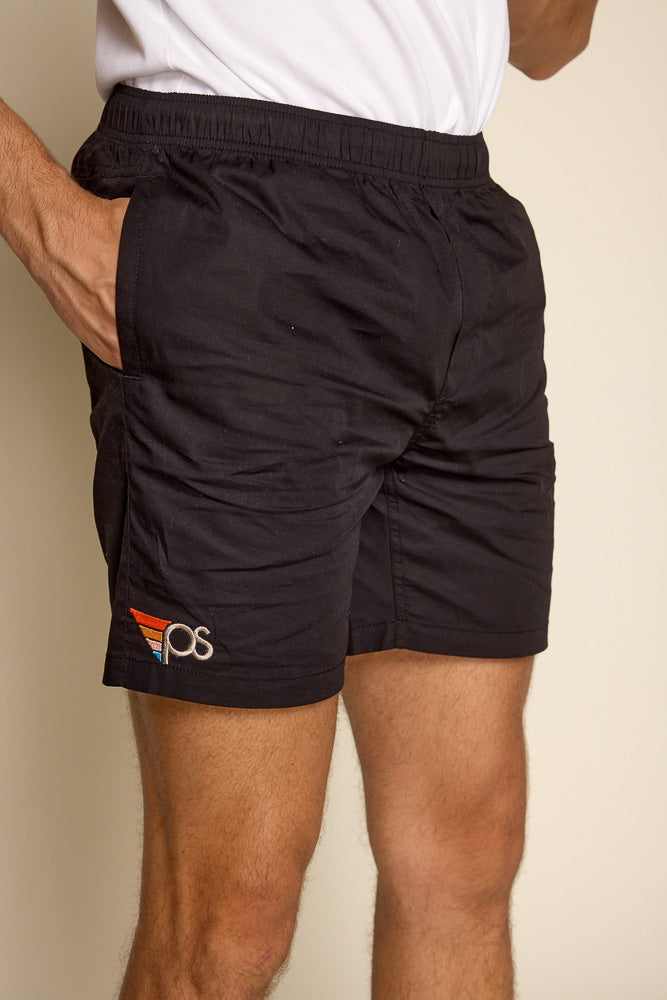 Cropped photo of male model wearing our "flying P" leauge black shorts