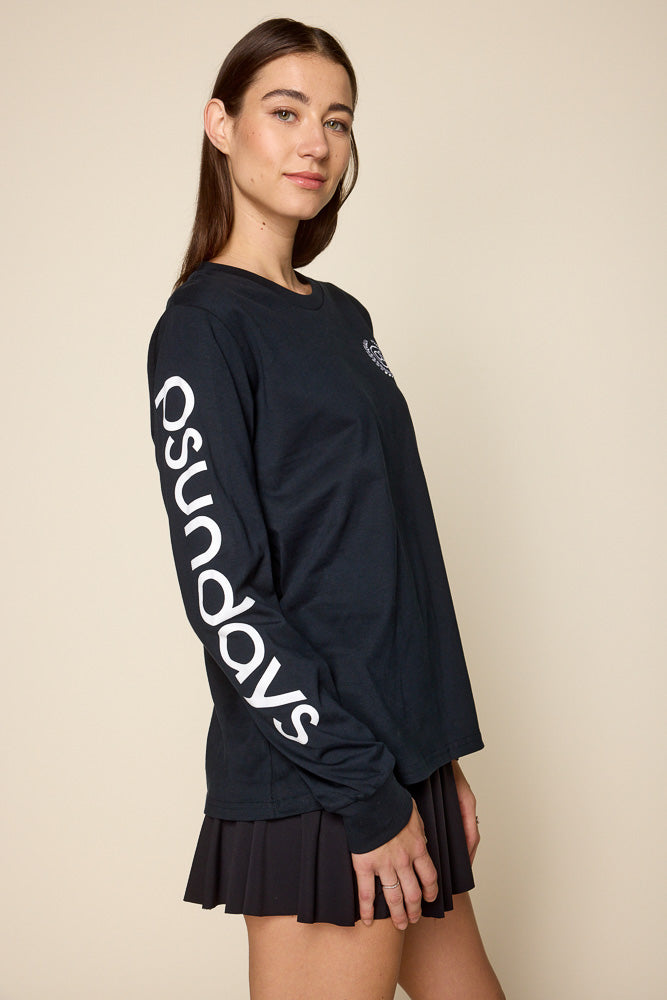 Side view of female model wearing black long sleeve tee. Graphic on the right sleeve in white with "Psunday" logo.