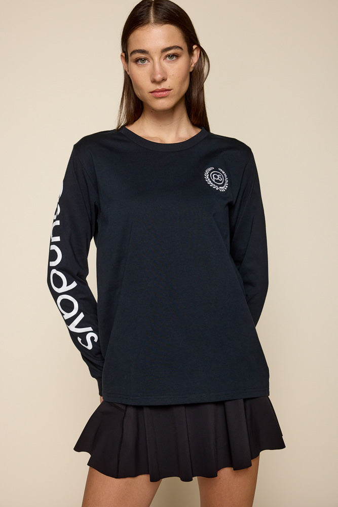 Cropped photo of female model wearing black long sleeve tee with Psunday's log written on the right sleeve and on the top left chest "ps" surrounded by victory wreath