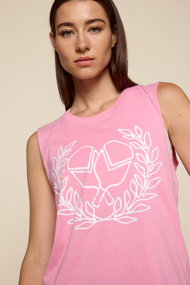 Close up of female model wearing a pink muscle shirt with criss cross white pickle ball paddle graphic surrounded by victory wreath.