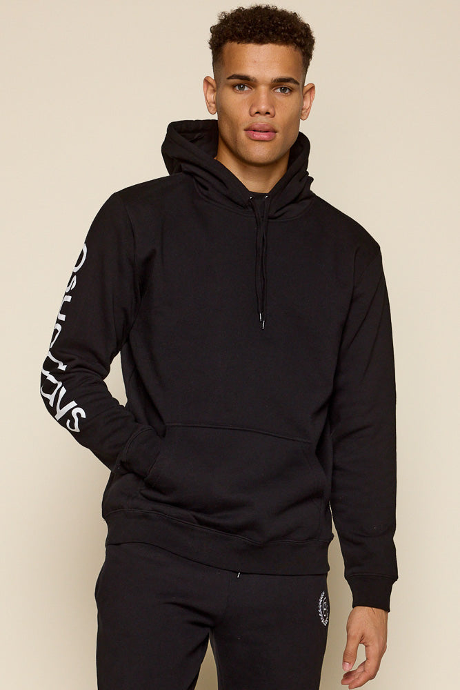 Cropped frontal view of male model sporting black hoodie with Psunday logo on sleeve on white print